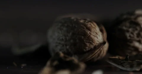 Nuts filmed in slow motion with a dark mood on a wooden background. Stock Footage 172158849