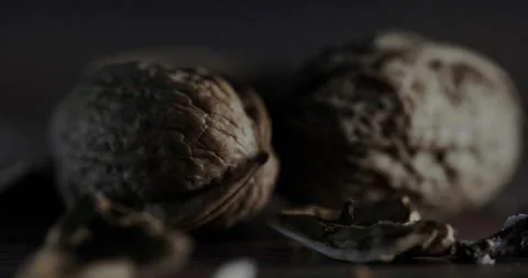 Nuts filmed in slow motion with a dark mood on a wooden background. Stock Footage 172158853