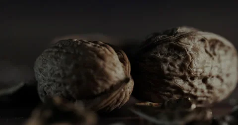 Nuts filmed in slow motion with a dark mood on a wooden background. Stock Footage 172158866