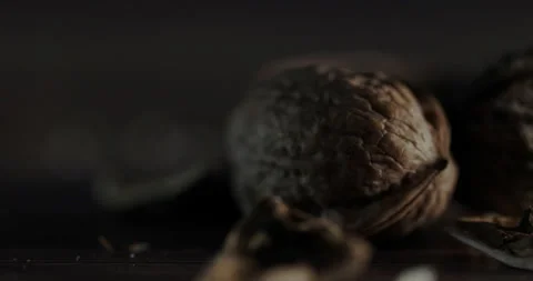 Nuts filmed in slow motion with a dark mood on a wooden background. Stock Footage 172158875