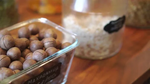 Nuts in glass jars on store shelf. Dried fruits and seeds in organic supermarket Stock Footage 202371825
