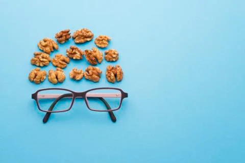 Nuts with glasses on a blue background Stock Photos