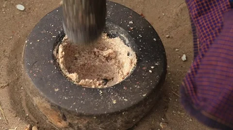 Nuts is grinded in a stone mortar in yard, Bagan. Myanmar . Close up Stock Footage 64053484