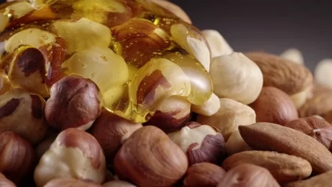 Nuts in honey Stock Footage 130876563
