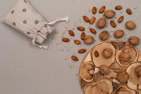 Nuts, inshell walnuts, peeled almonds, peeled sunflower seeds, sprinkled on a Stock Photos