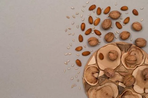 Nuts, inshell walnuts, peeled almonds, peeled sunflower seeds, sprinkled on a Stock Photos