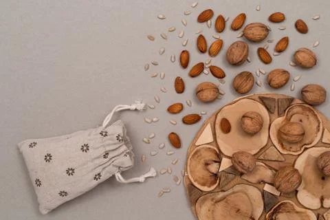 Nuts, inshell walnuts, peeled almonds, peeled sunflower seeds, sprinkled on a Stock Photos