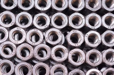 Nuts in internal thread, are folded in a row. background Foto stock