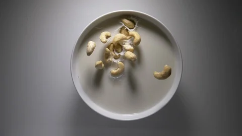 Nuts into Milk - Slow motion Stock Footage 91826107