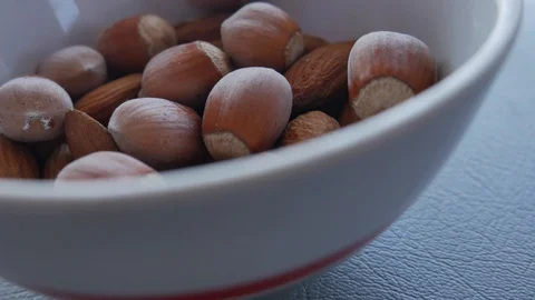 Nuts Mix.  Almonds and Hazelnut. Hazelnut Falling to Almonds. Stock Footage 118702513