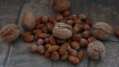 Nuts Mix. Walnuts, Almonds and Hazelnuts are on the Stone Surface Stock Footage 118954904