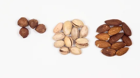 Nuts mix on a white background. Pistachio, hazelnuts, almonds. Stop motion. 4k Stock-Footage 88398915