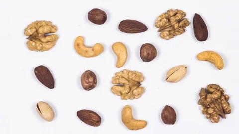 Nuts move on a white table. Pistachio, hazelnuts, almonds,cashew, peanuts 스톡 동영상 88399083