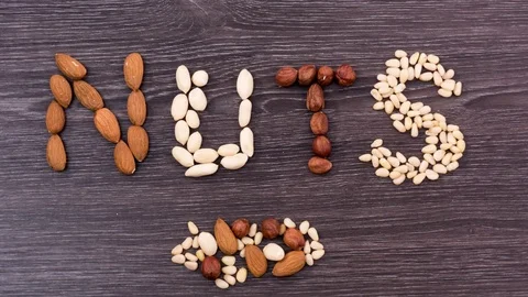 Nuts moving into a word NUTS. Stop motion Stock-Footage 72717109