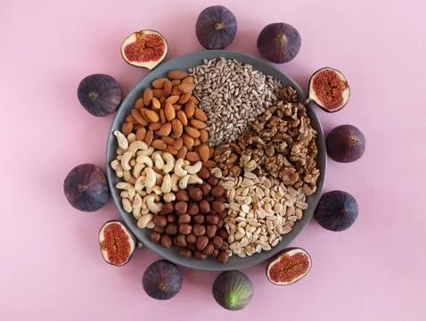 Nuts plate and figs Stock Photos