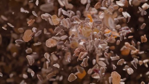 Nuts, seeds and dried fruit fly after being exploded. Slow Motion. Stock Footage 76230293