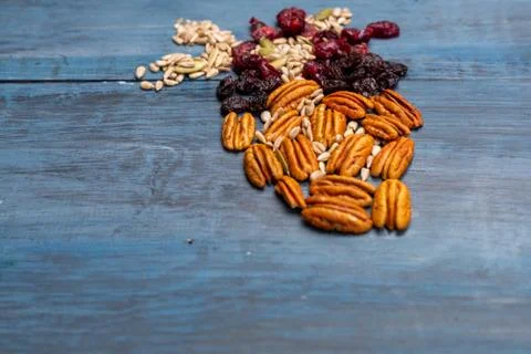 Nuts in the shape of a human heart with walnut, raisins, pumpkin seeds, dried Stock Photos