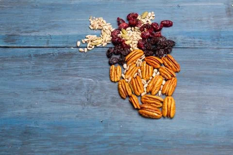 Nuts in the shape of a human heart with walnut, raisins, pumpkin seeds, dried Stock Photos