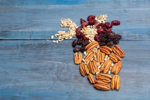 Nuts in the shape of a human heart with walnut, raisins, pumpkin seeds, dried Stock Photos