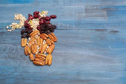 Nuts in the shape of a human heart with walnut, raisins, pumpkin seeds, dried Stock Photos