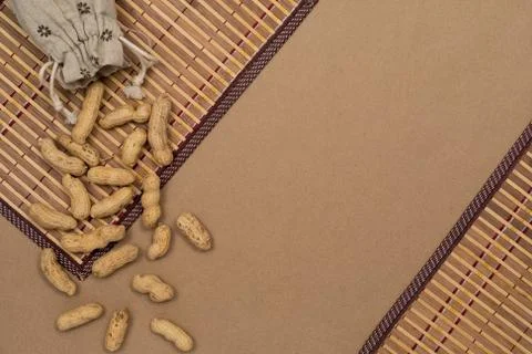 Nuts, shelled peanuts, sprinkle on the table from a linen bag, kraft paper Stock Photos