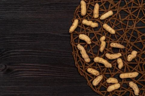 Nuts, shelled peanuts, sprinkle on the table from a linen bag, wooden background Stock Photos