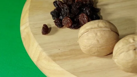 Nuts spread out by handfuls rotate 360 degrees on a wooden platform Stock Footage 119842590