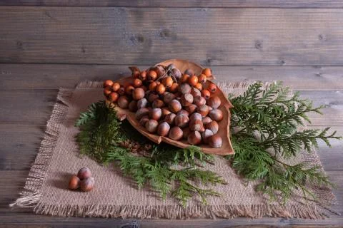 Nuts on a tray and on a table Stock Photos
