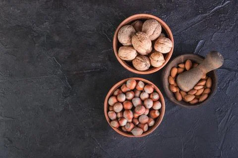 Nuts, walnuts, hazelnuts and mintal on a dark background with a place by text Stock Photos