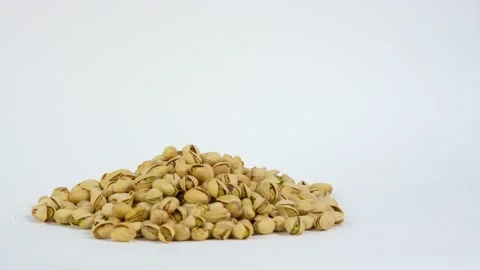 Nuts on white.  Pistachio nuts on white background. Video stock 233171298