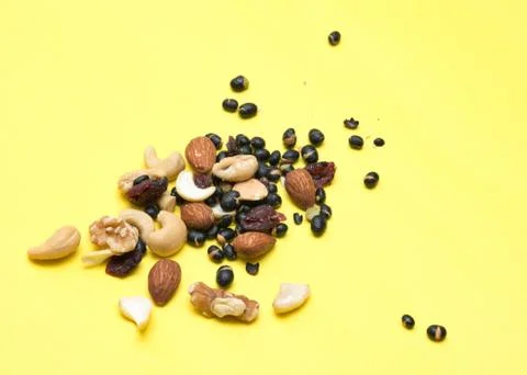 Nuts on yellow background Stock Photos
