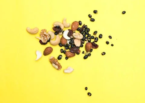 Nuts on yellow background Stock Photos
