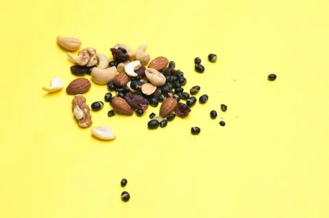 Nuts on yellow background Stock Photos