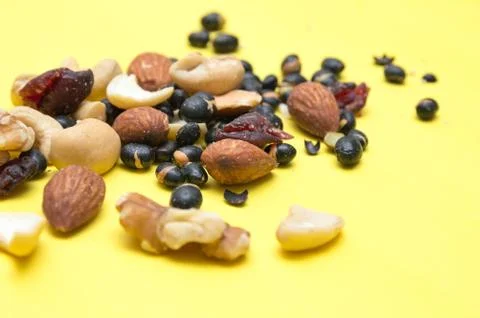 Nuts on yellow background Stock Photos