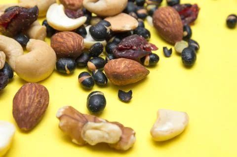 Nuts on yellow background Stock Photos