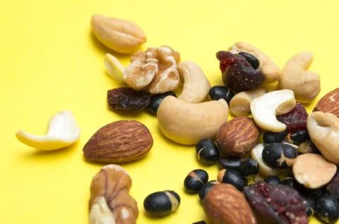 Nuts on yellow background Stock Photos