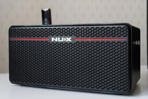 NUX Mighty Space - mini electric guitar amplifier on table. Stock Photos