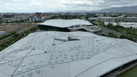 Nvidia headquarters with iconic diamond-faceted roof over glass facade Stock Footage 336450813