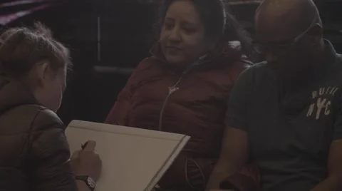 NY Time Square People are sitting to be drawn Stock Footage 40367668
