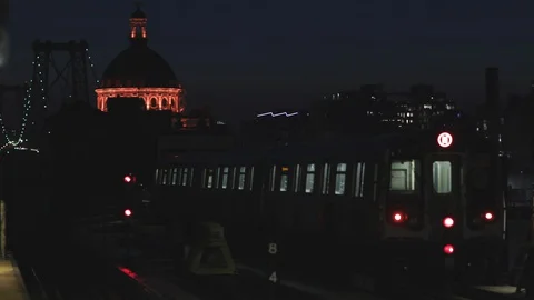 NYC Elevated Subway train departing station at night Stock Footage 129711142