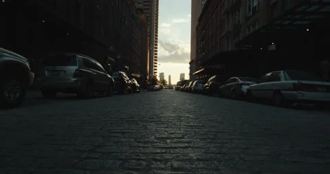 NYC Manhattan low to ground middle of cobblestone street sunrise Stock Footage 217939053