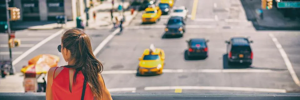 NYC New York City travel tourist woman looking at car traffic on Manhattan Stock Photos