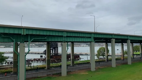 NYC - Runners &amp; Cyclists exercise on Hudson River Greenway past Pier I Gantry Video stock 117620236