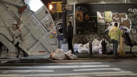 NYC Sanitation workers loading Dump Truck in Manhattan at Night Stock Footage 200793837