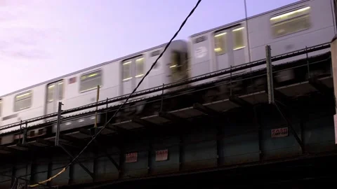 NYC Subway on elevated Tracks during Sunset. 7 Train in Queens at twilight Stock Footage 199999439