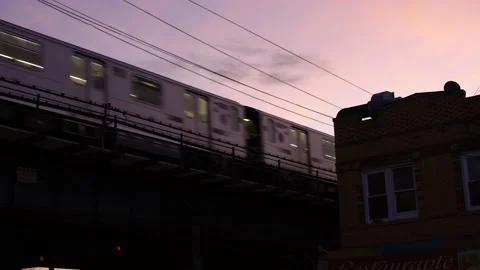 NYC Subway on elevated Tracks during Sunset. 7 Train in Queens at twilight Stock Footage 199999711