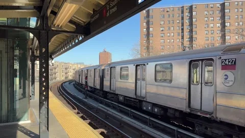 NYC subway leaving the elevated Dyckman Street station in Inwood Stock Footage 310698246