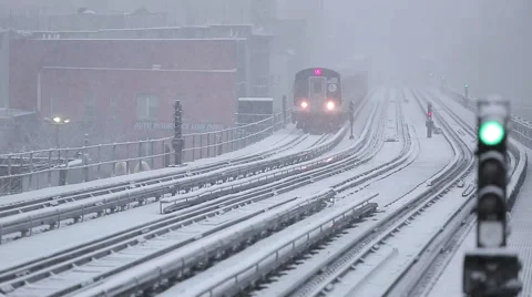 NYC subway train pulls into station on a snowy day Stock Footage 63321022