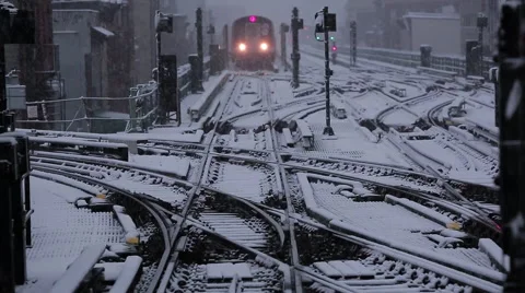 NYC subway train pulls into station on a snowy day Stock Footage 63321073