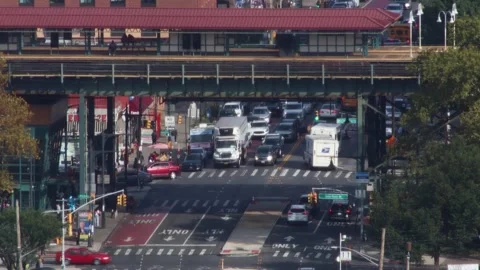 NYC traffic below elevated subway tracks, aerial view, cars at intersection, 4K Stock Footage 339910843